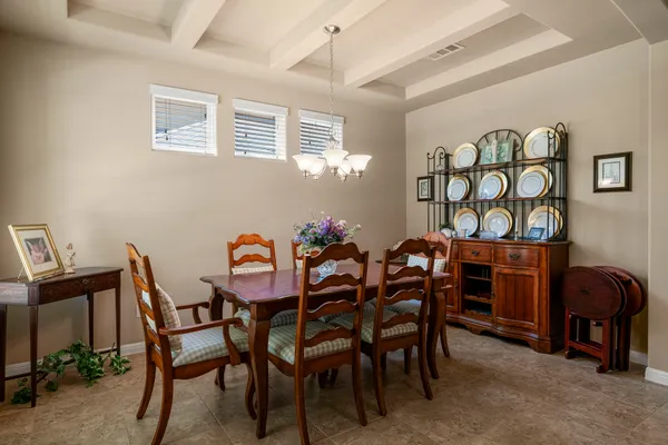 a view of a dining room with furniture and chandelier