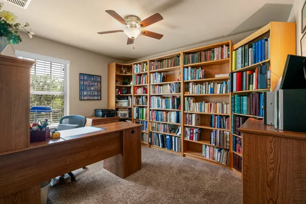 a room with a book shelf and a window