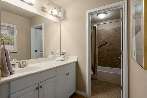a bathroom with double vanity and a mirror