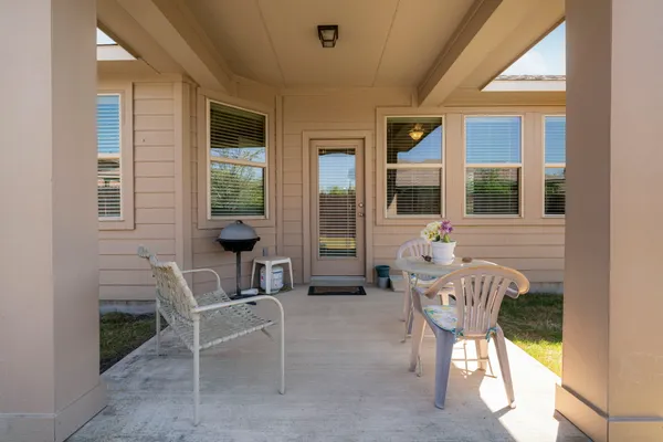 a view of a house with outdoor seating space