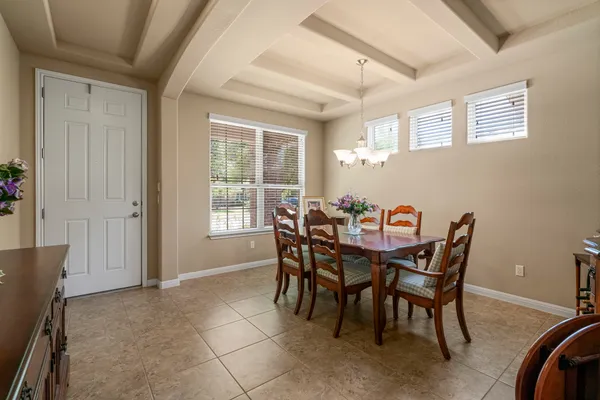 a dining room with furniture and window