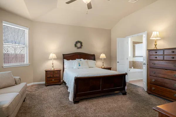 a bedroom with a bed and a dresser