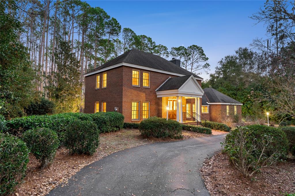 8022 Southwest 45 Lane Gainesville, FL 32608 - Photo 1 of 1 a front view of a house with a yard