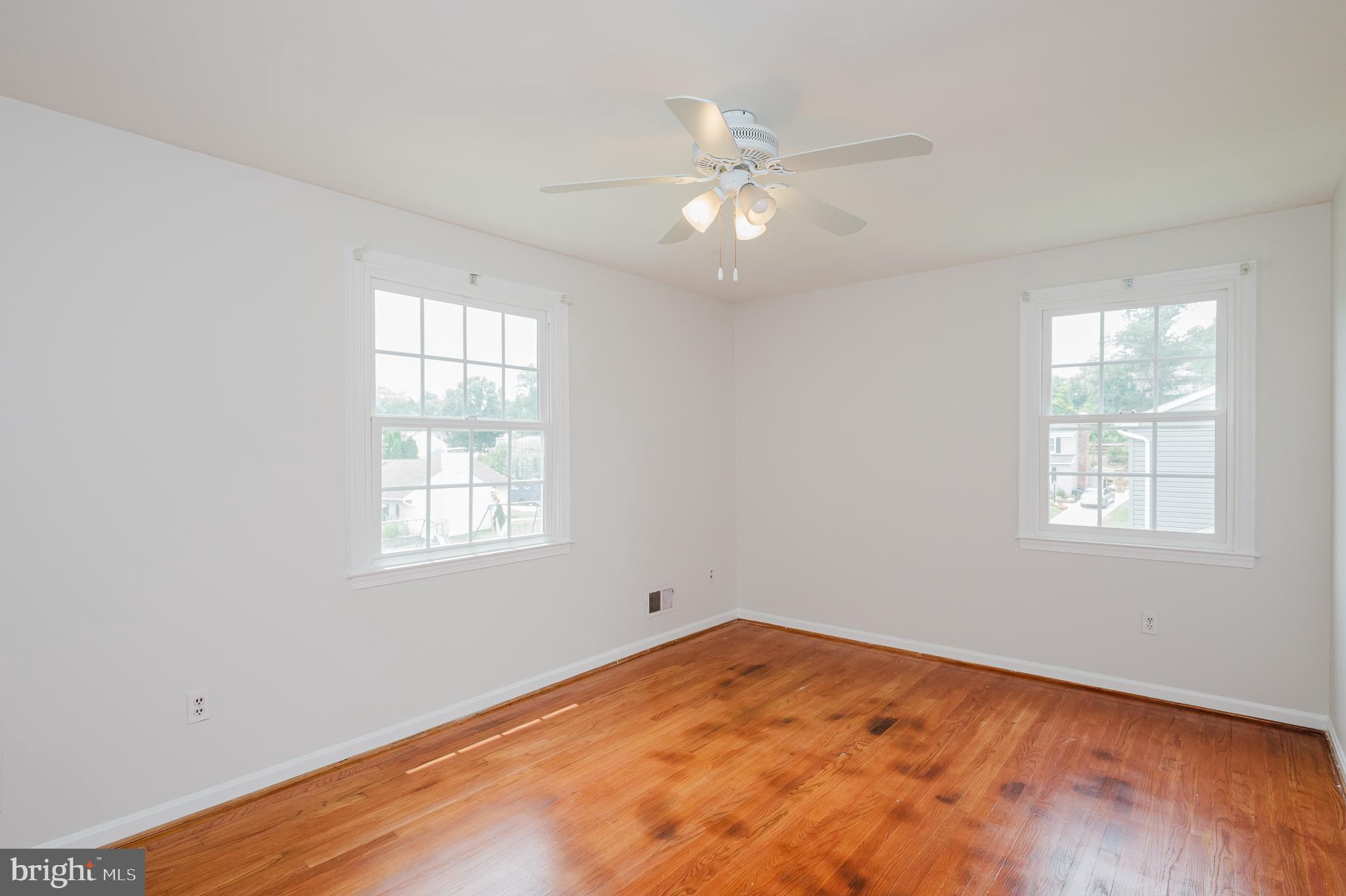 4 Old Spring Court Cockeysville, MD 21030 - Photo 35 of 53 an empty room with wooden floor fan and windows