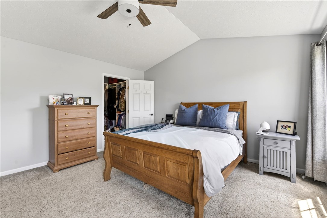 39 Holly Court Springboro, OH 45066 - Photo 21 of 42 A well-appointed bedroom featuring a sloped ceiling, providing a serene and comfortable retreat.