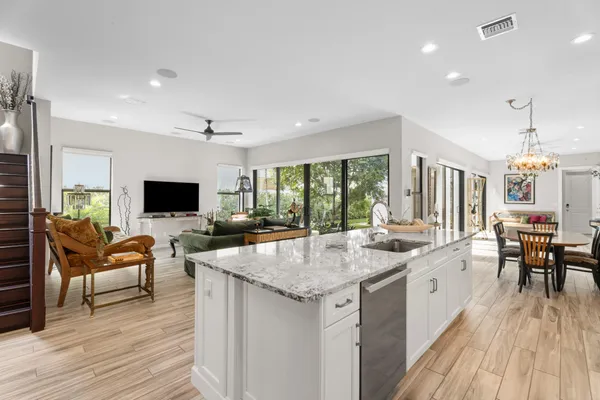 a open kitchen with sink stove and dining table with chair