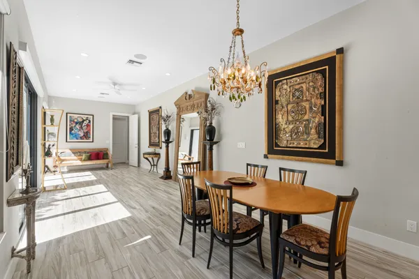 a view of a dining room with furniture and chandelier