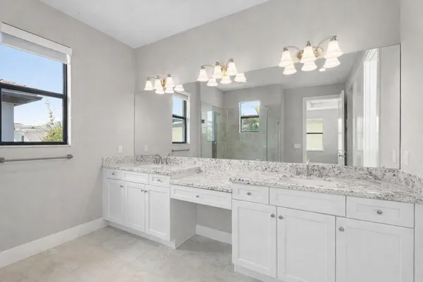 a bathroom with a sink vanity granite and a mirror