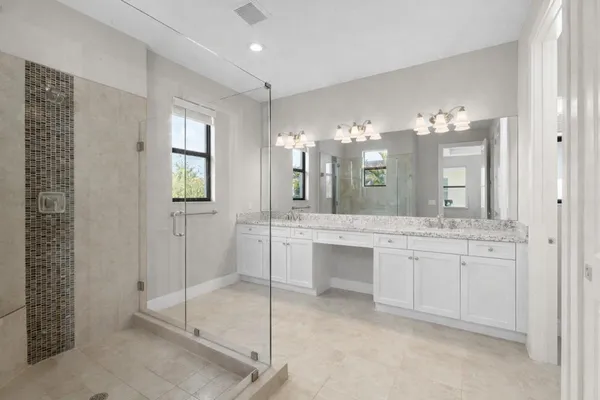 a bathroom with a double vanity sink and a mirror