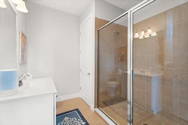 a bathroom with a shower and a sink