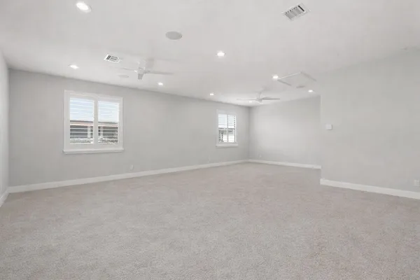 an empty room with windows and closet