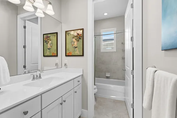 a bathroom with a shower a sink and a mirror
