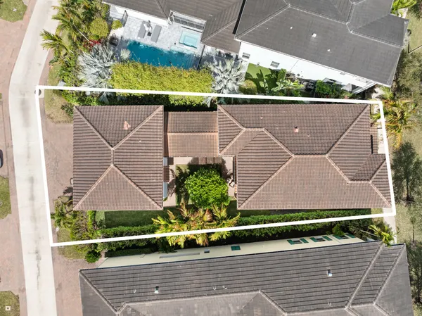 an aerial view of a house with a yard and potted plants