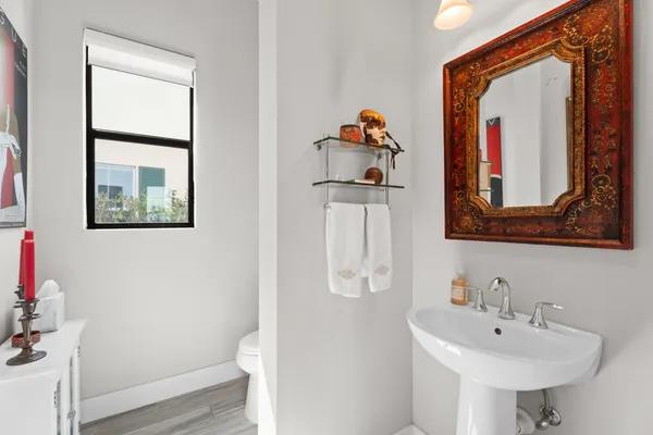 a bathroom with a toilet sink and mirror