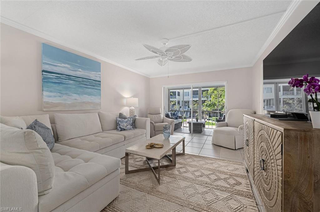 333 4th Avenue South, Unit 202 Naples, FL 34102 - Photo 1 of 16 a living room with furniture and a flat screen tv