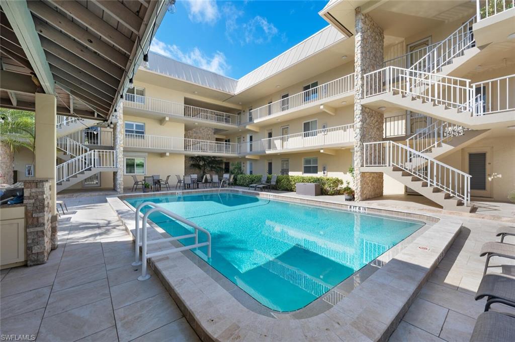 333 4th Avenue South, Unit 202 Naples, FL 34102 - Photo 12 of 16 an outdoor space with swimming pool and furniture