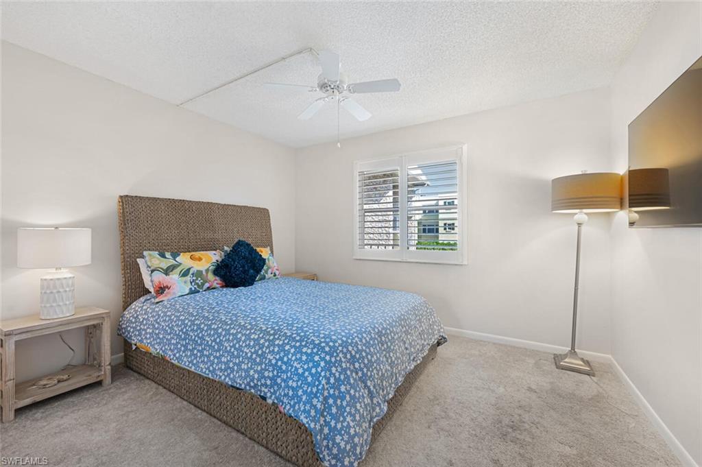 333 4th Avenue South, Unit 202 Naples, FL 34102 - Photo 13 of 16 a bedroom with a bed and a window