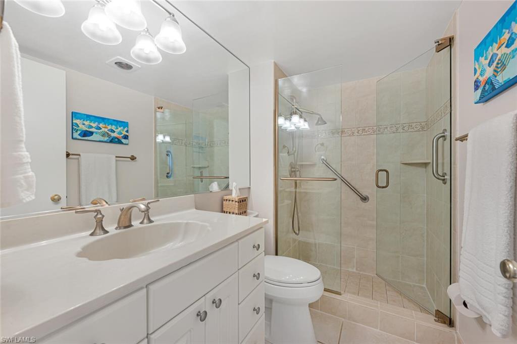 333 4th Avenue South, Unit 202 Naples, FL 34102 - Photo 14 of 16 a bathroom with a sink a toilet and shower