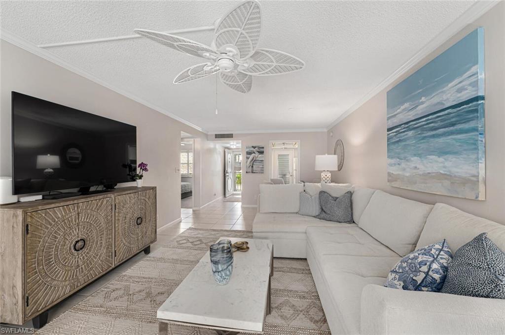 333 4th Avenue South, Unit 202 Naples, FL 34102 - Photo 6 of 16 a living room with furniture and a flat screen tv