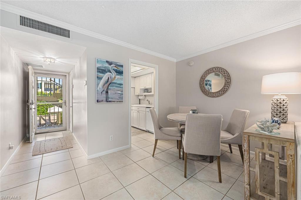 333 4th Avenue South, Unit 202 Naples, FL 34102 - Photo 7 of 16 a view of a livingroom with furniture and a chair