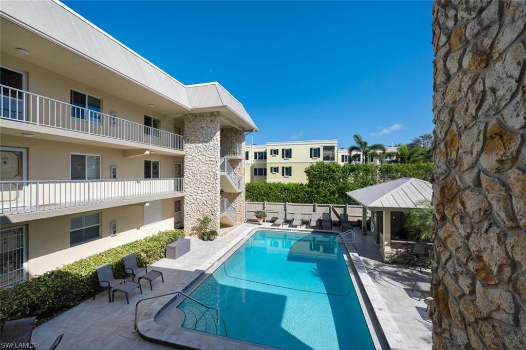 333 4th Avenue South, Unit 202 Naples, FL 34102 - Photo 9 of 16 a view of a patio with furniture and a yard