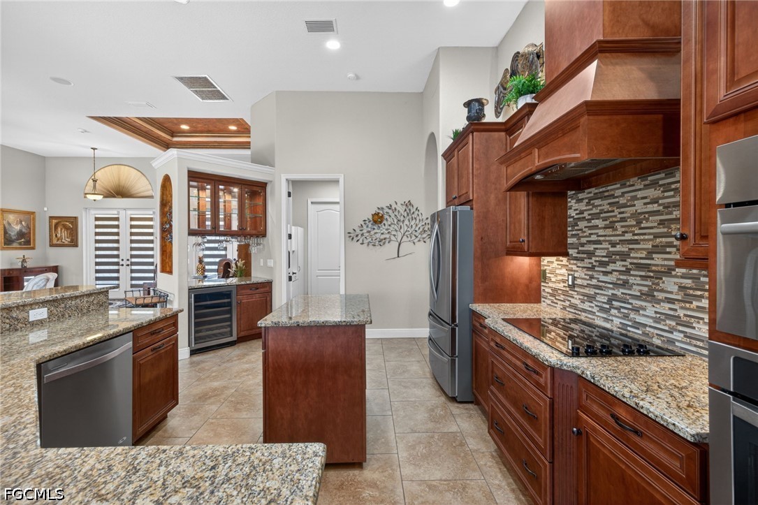 6109 Calusa Rdg Trail Bokeelia, FL 33922 - Photo 21 of 48 a kitchen with stainless steel appliances granite countertop a stove a sink and a refrigerator