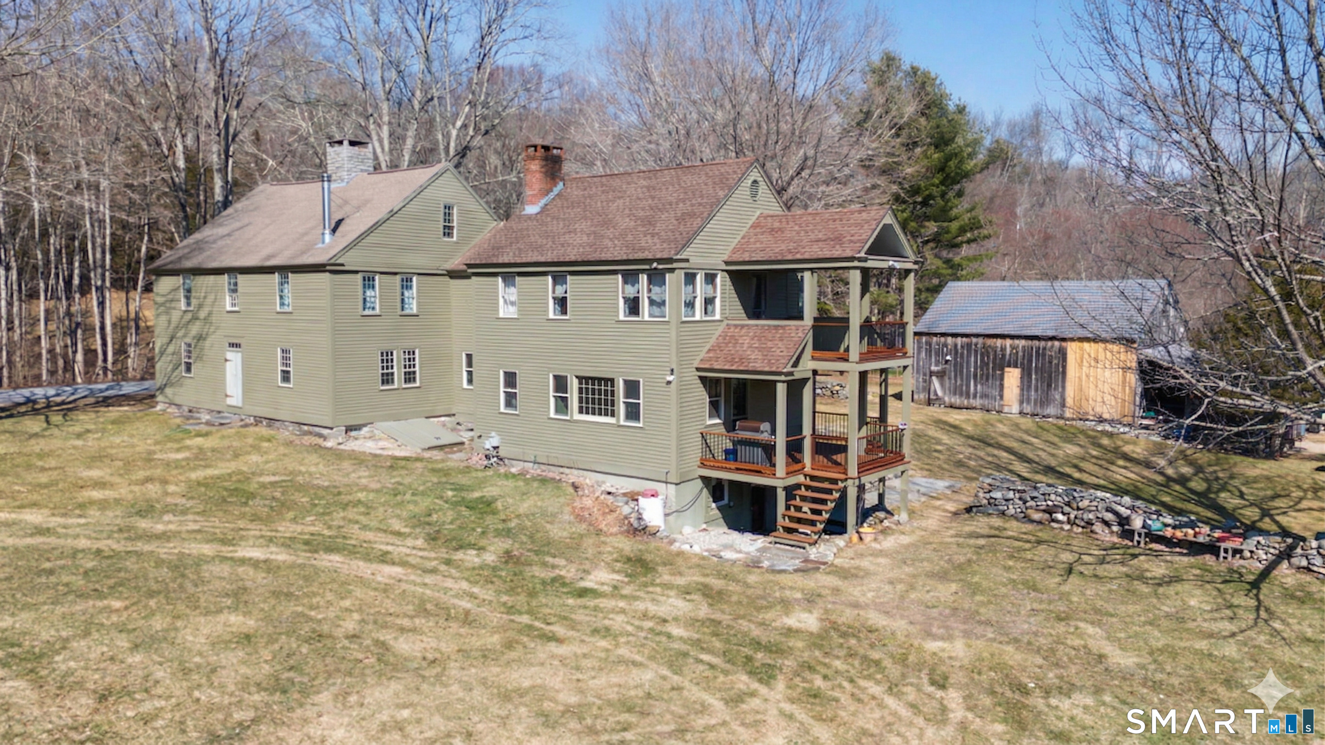 a front view of a house with a yard covered in snow