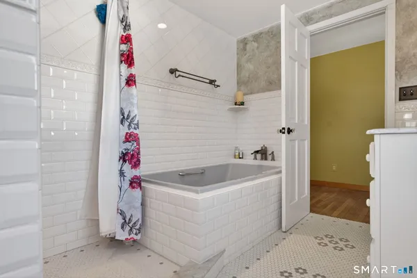 a bathroom with a bathtub and shower
