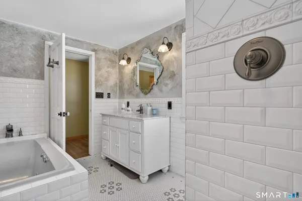 a bathroom with a sink a mirror and bathtub