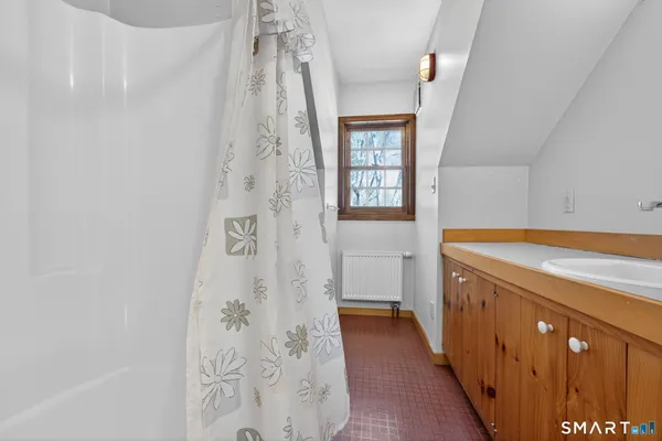 a bathroom with a sink a mirror and a shower