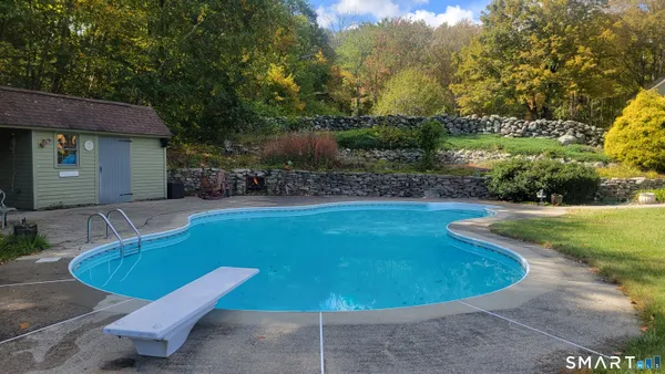 a view of a swimming pool with a yard