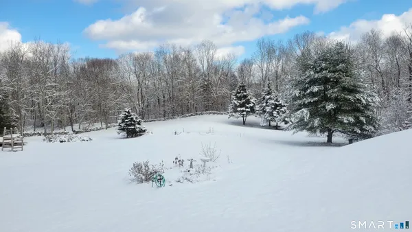 a view of water covered with snow in front of house