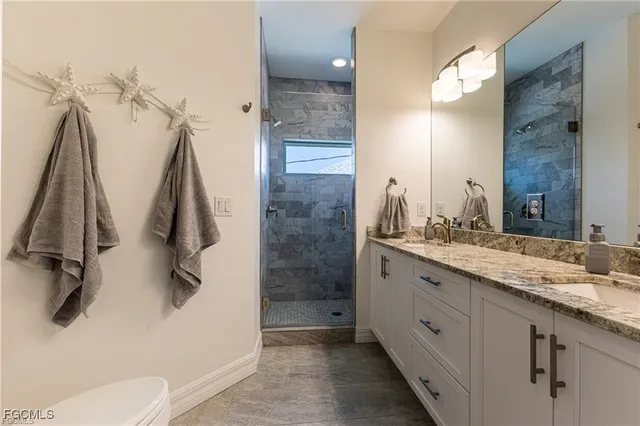a bathroom with a double vanity sink and mirror