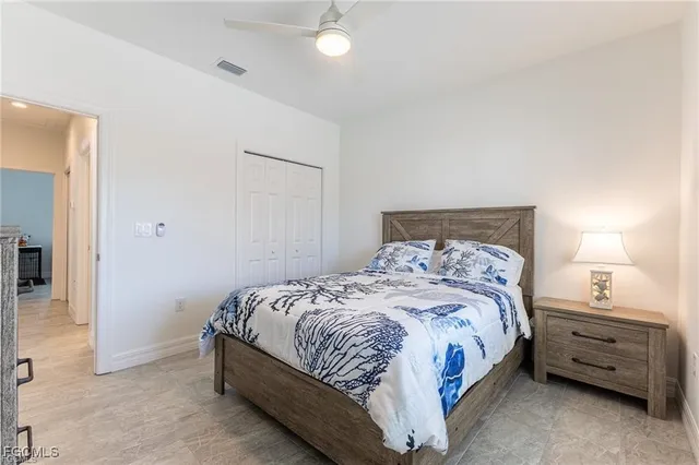 a bedroom with a bed and a night stand