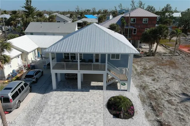 an aerial view of a house with a yard and potted plants