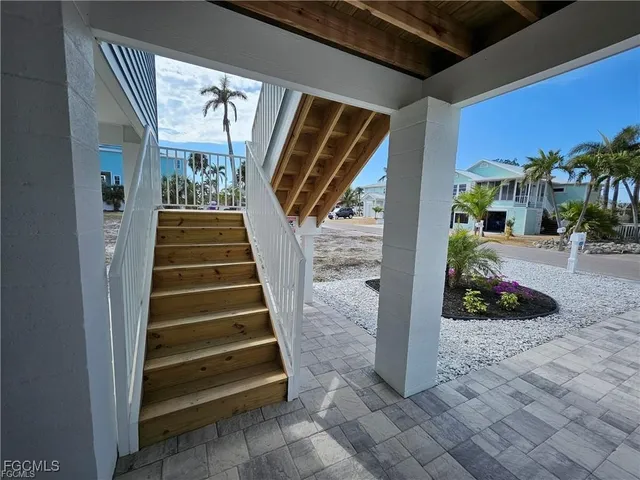 a view of a house with a patio and a yard