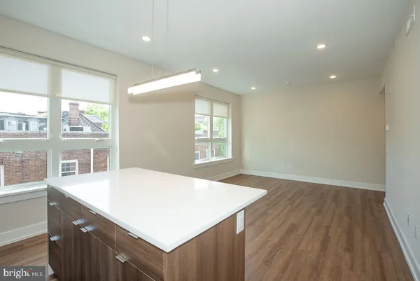 a kitchen with a wooden floor and large window
