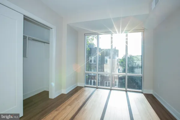 a view of a room with wooden floor and balcony