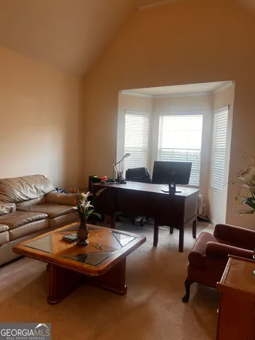 a living room with furniture pool and a table
