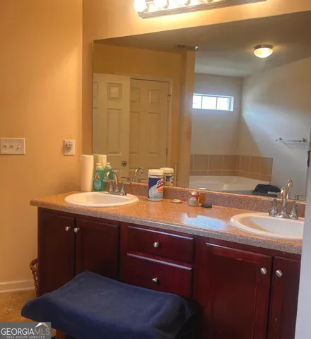 a bathroom with a double vanity sink and a mirror