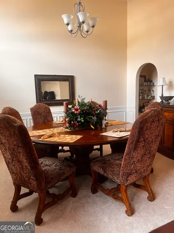 a living room with furniture and a chair