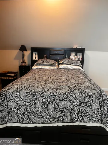 a bedroom with a bed and a chair