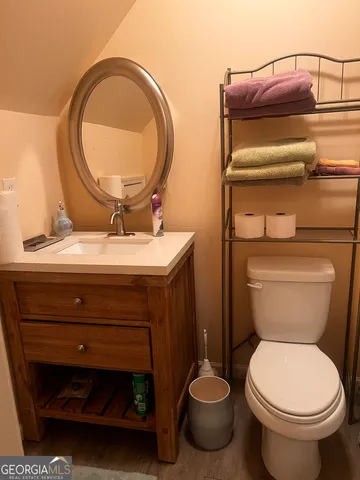 a bathroom with a toilet and a mirror