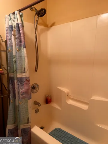 a bathroom with a shower and a toilet