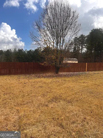 a backyard of a house with lots of green space