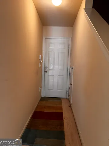 a room with walk in closet and wooden floor