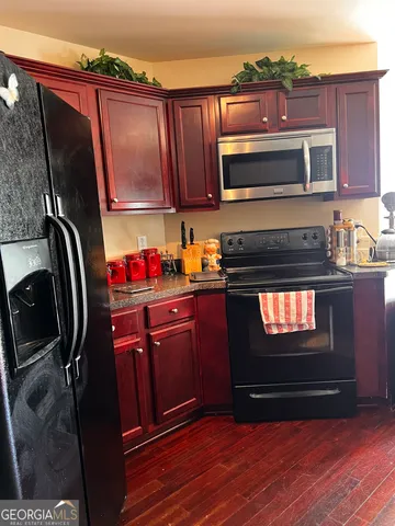 a kitchen with stainless steel appliances granite countertop a stove and a microwave