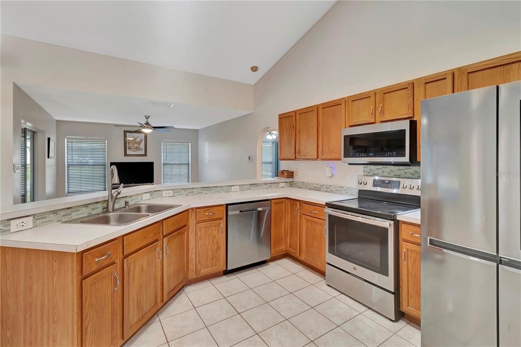18611 Clark Road Altoona, FL 32702 - Photo 22 of 48 a kitchen with a sink stove and microwave