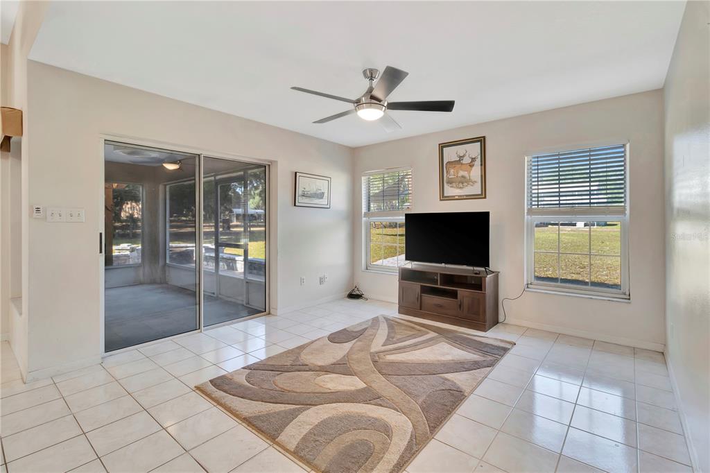 18611 Clark Road Altoona, FL 32702 - Photo 26 of 48 a living room with furniture and a flat screen tv