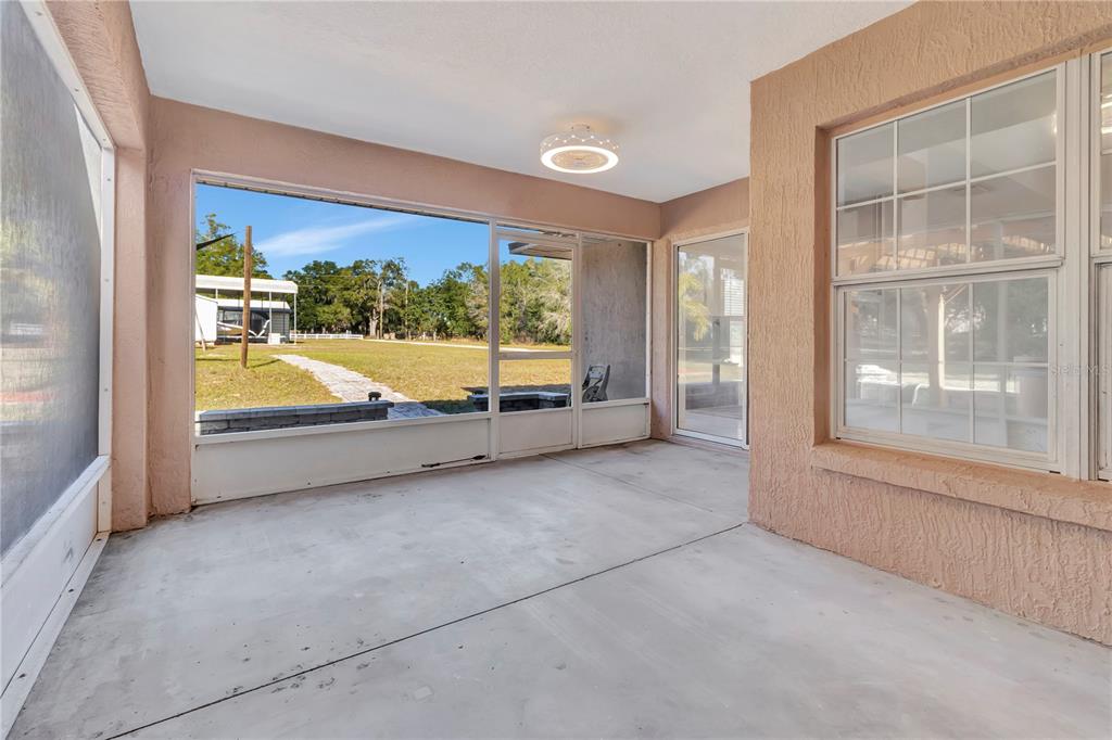 18611 Clark Road Altoona, FL 32702 - Photo 40 of 48 an empty room with wooden floor and windows